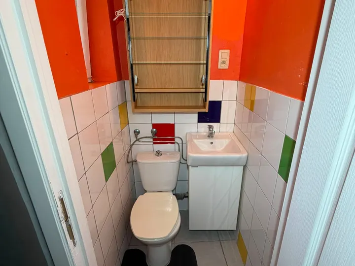 Toilettes séparées dans une pièce aux tons orange